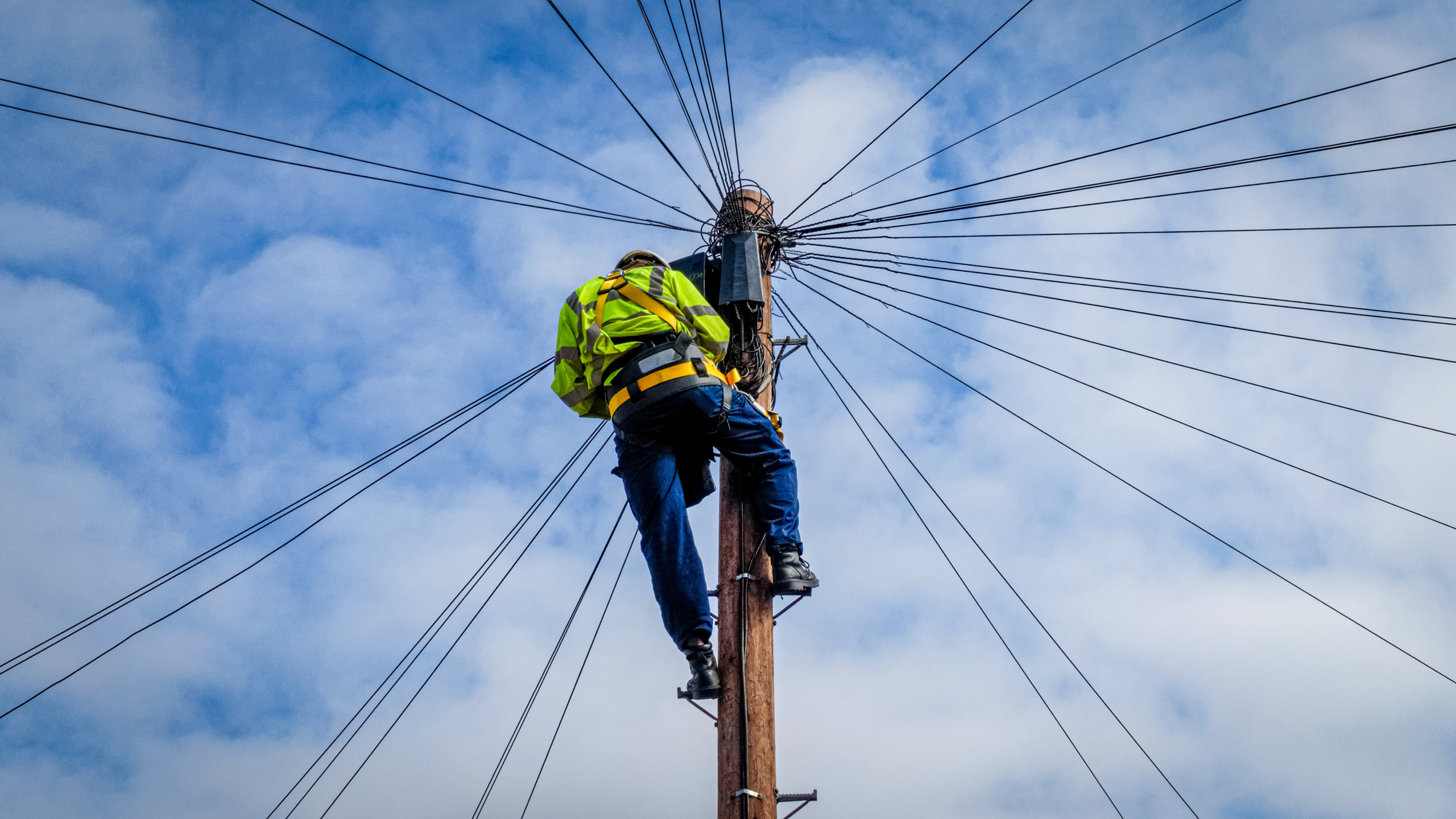 Openreach engineer working on UK telephone exchange copper cabling ahead of the PSTN switch off deadline.