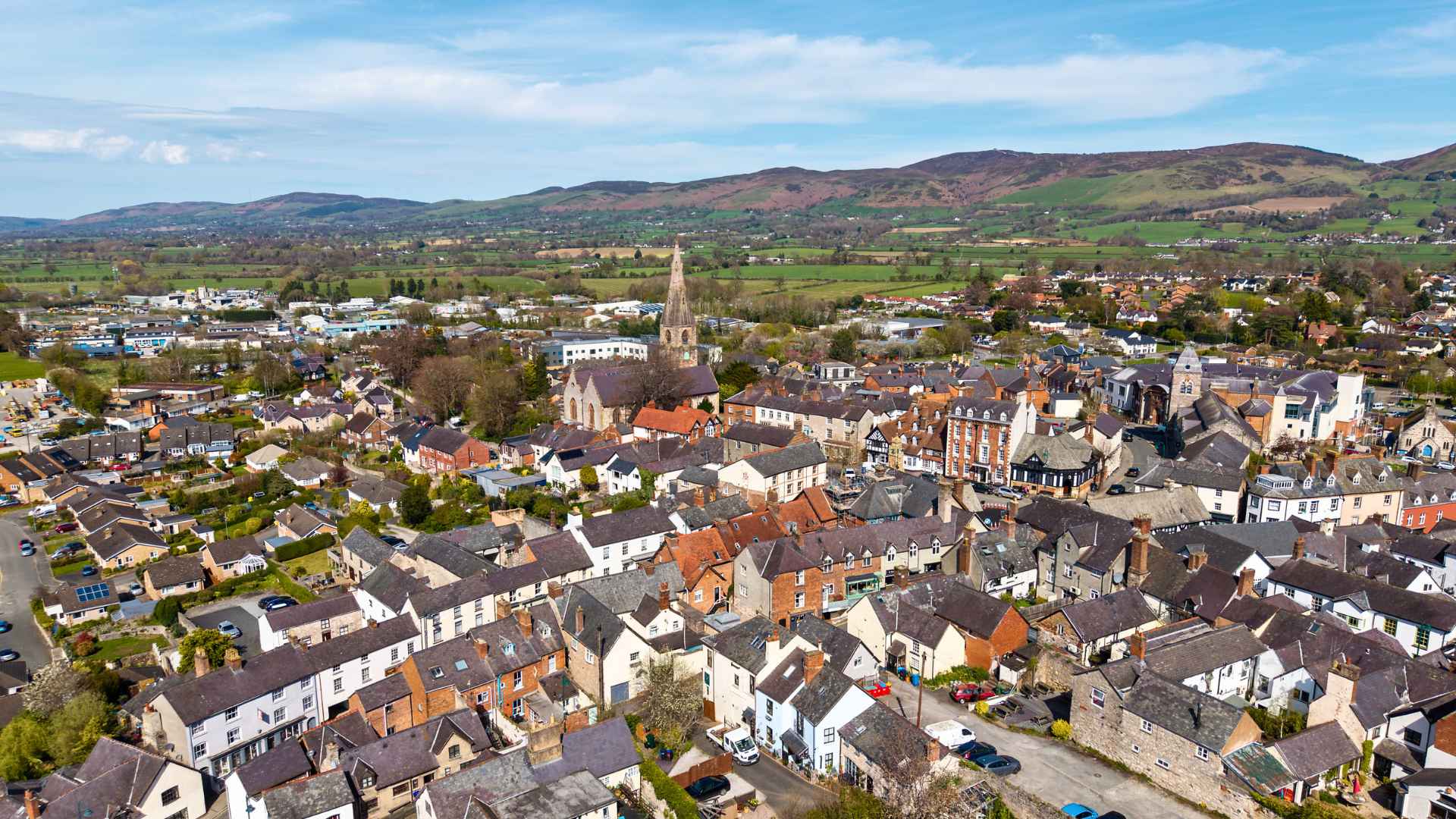 Aerial view of Ruthin in Denbighshire with the Clwydian Range behind, as rural full fibre broadband expands across North Wales.